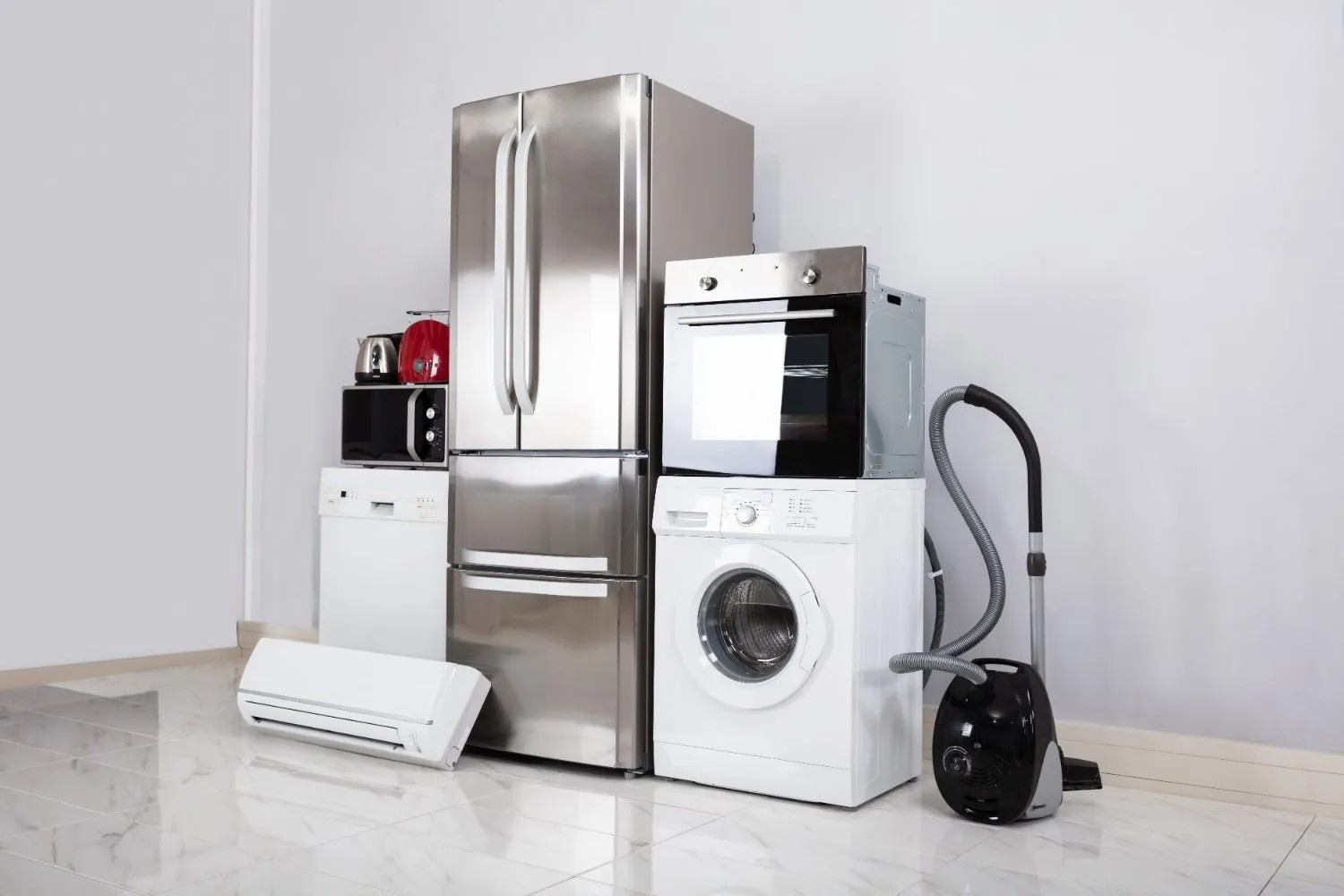 Fridge, oven, washer and other home appliances lined up in a room